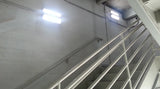 Commercial LED stairwell lighting fixture installed in stairwell